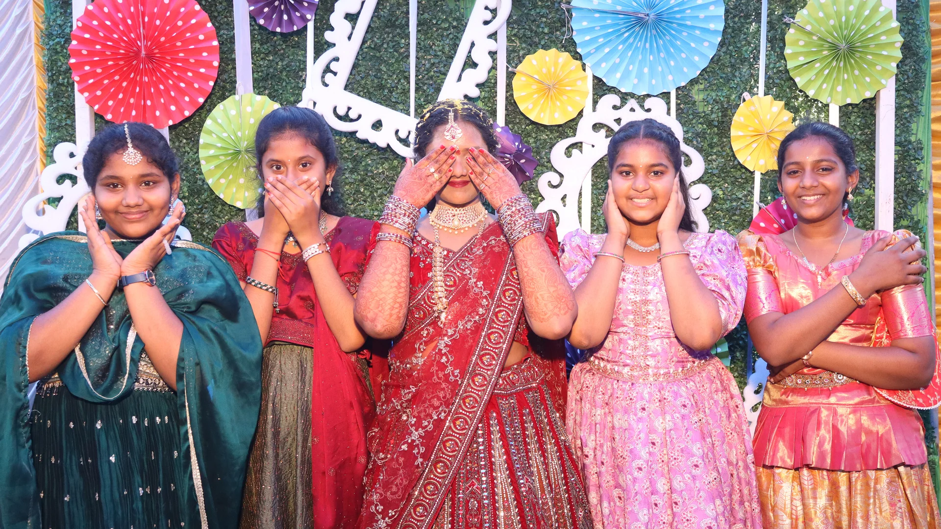 Guests posing at an OctoSnap photo booth with a colourful celebration backdrop
